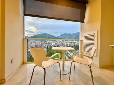 a room with a table and chairs and a large window at The Royal Suite - Tre Canne in Budva