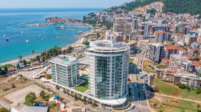 an aerial view of a city and the ocean at The Royal Suite - Tre Canne in Budva