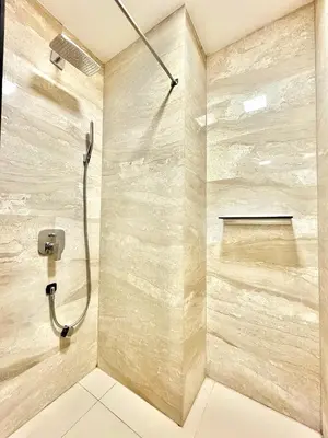 a bathroom with a shower with a shower head at The Royal Suite - Tre Canne in Budva