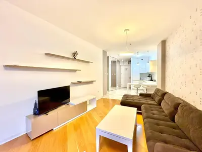 a living room with a couch and a tv at The Royal Suite - Tre Canne in Budva