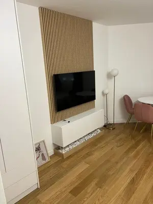a living room with a flat screen tv on a wall at Studio apartman Vivo Central in Podgorica