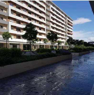 a large apartment building with a walkway in front of it at Studio apartman Vivo Central in Podgorica