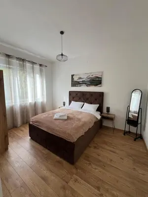 a bedroom with a large bed and a chair at Old Capital in Cetinje