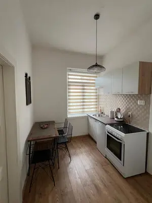 a kitchen with a table and a stove top oven at Old Capital in Cetinje