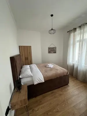 a bedroom with a large bed and a wooden floor at Old Capital in Cetinje