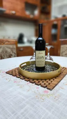 a bottle of wine on a tray on a table at Vila Marija in Podgorica