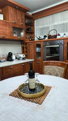 a bottle of wine sitting on a plate on a table at Vila Marija in Podgorica