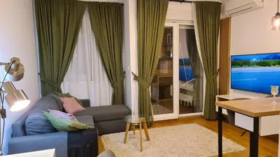 a living room with a couch and a television at Marina City key Luxury Studio in Podgorica