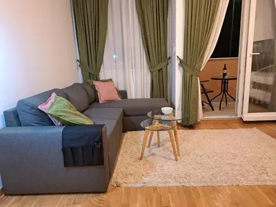 a living room with a couch and a table at Marina City key Luxury Studio in Podgorica