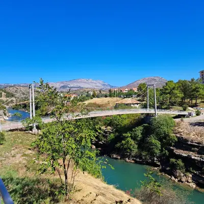 a bridge over a river next to a river at Marina City key Luxury Studio in Podgorica