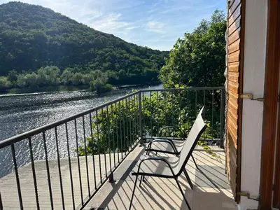 a chair sitting on a balcony overlooking a river at Sunny Terraces in Cetinje