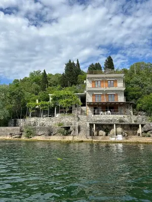 a house on an island in the water at Sunny Terraces in Cetinje