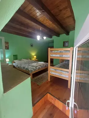 a room with two bunk beds in a green wall at Omni S Apartments in Bar