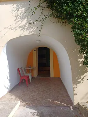 an archway with two chairs and a table in a building at Omni S Apartments in Bar