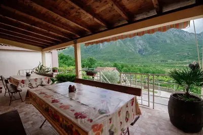 a room with two tables and a view of a mountain at Omni S Apartments in Bar