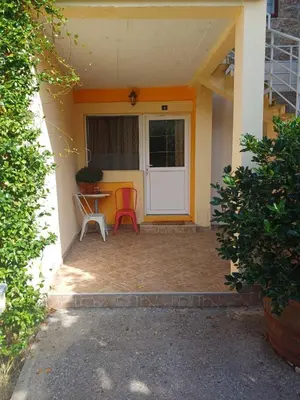 a porch of a house with a table and chairs at Omni S Apartments in Bar