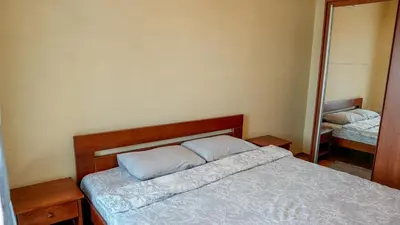 a bedroom with a bed and a mirror at Modern Apartment in City Center in Podgorica