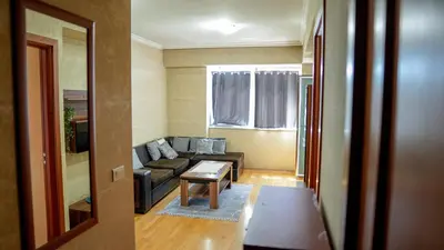 a living room with a couch and a table at Modern Apartment in City Center in Podgorica