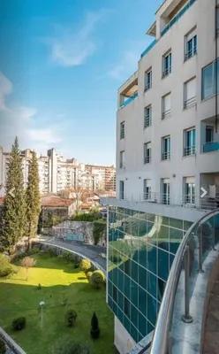an image of a building with a garden at Modern Apartment in City Center in Podgorica