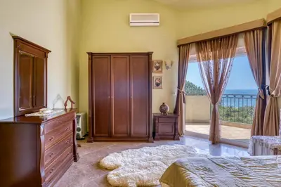 a bedroom with a bed and a dresser and a window at The view villa in Petrovac na Moru