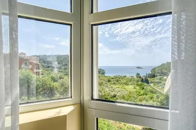 a window with a view of the ocean at The view villa in Petrovac na Moru