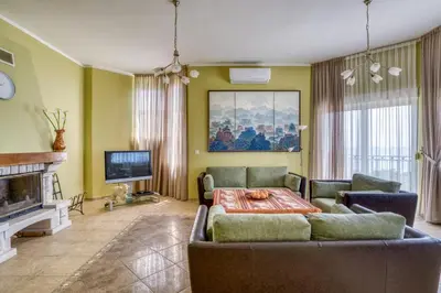 a living room with a couch and a tv at The view villa in Petrovac na Moru