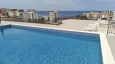 a swimming pool on the roof of a building at Nicks sea view apartment I in Bar