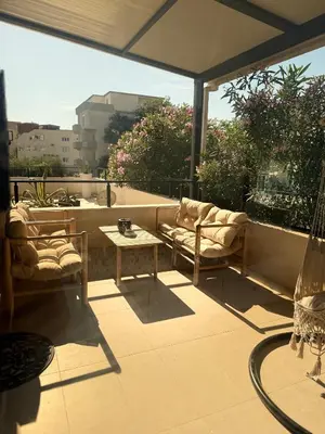 a patio with couches and a table on a balcony at Nicks sea view apartment I in Bar