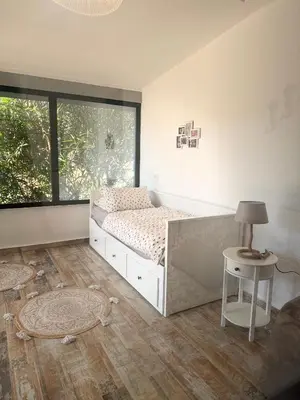 a bedroom with a bed and a table and a window at Nicks sea view apartment I in Bar