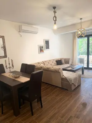 a living room with a couch and a table at Nicks sea view apartment I in Bar