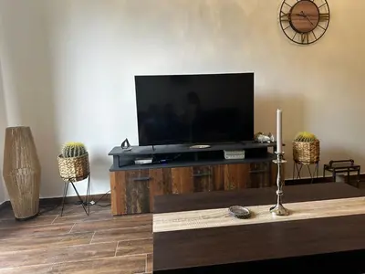 a living room with a flat screen tv on a table at Nicks sea view apartment I in Bar