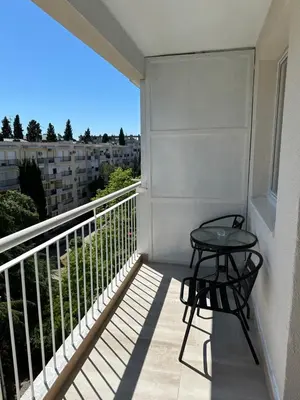 a balcony with a table and a view of a building at Alex Apartments in Podgorica