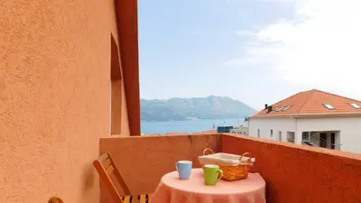 a table with two cups on top of a balcony at Villa Jovana Sea View in Budva