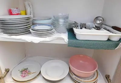 a shelf with plates and bowls and dishes on it at Villa Jovana Sea View in Budva