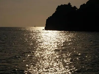 a body of water with the sun reflecting on the water at Villa Jovana Sea View in Budva