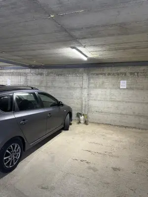 a silver car parked in a parking garage at Apartman Diplomat in Budva