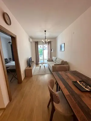a living room with a table and a couch at Apartman Diplomat in Budva