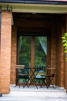 a balcony with a table and two chairs in front of a window at Paradise Valley in Rvaši