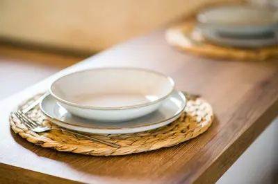 a bowls and plates on a wooden table at Paradise Valley in Rvaši