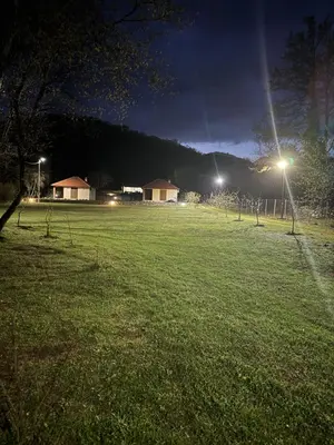 a field at night with lights in the grass at Paradise Valley in Rvaši