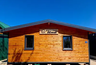 a log cabin with a sign on top of it at Ada Bojana kucica Una in Ulcinj