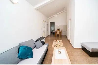 a living room with a couch and a table at Apartment Pavle near the center with a view in Kotor