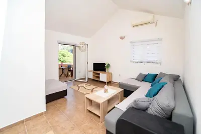 a living room with a couch and a table at Apartment Pavle near the center with a view in Kotor