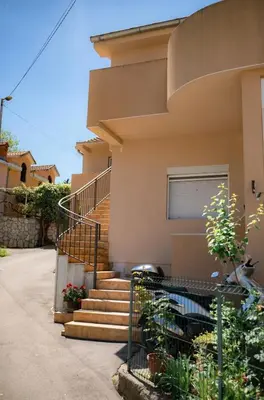 a house with stairs in front of it at Apartment Pavle near the center with a view in Kotor