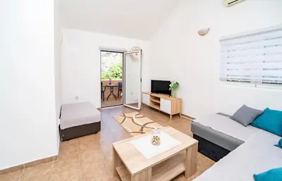 a living room with a couch and a table at Apartment Pavle near the center with a view in Kotor