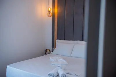 a bedroom with a bed with towels on it at Cataleya Resort in Ulcinj