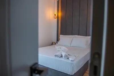 a bedroom with a bed with towels on it at Cataleya Resort in Ulcinj