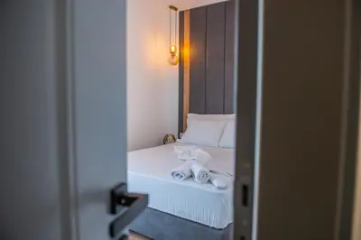 a bedroom with a bed with towels on it at Cataleya Resort in Ulcinj