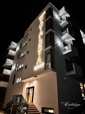 a building with a sign on the side of it at Cataleya Resort in Ulcinj