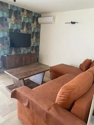 a living room with a couch and a table at Apartmani Radmanovic in Tivat